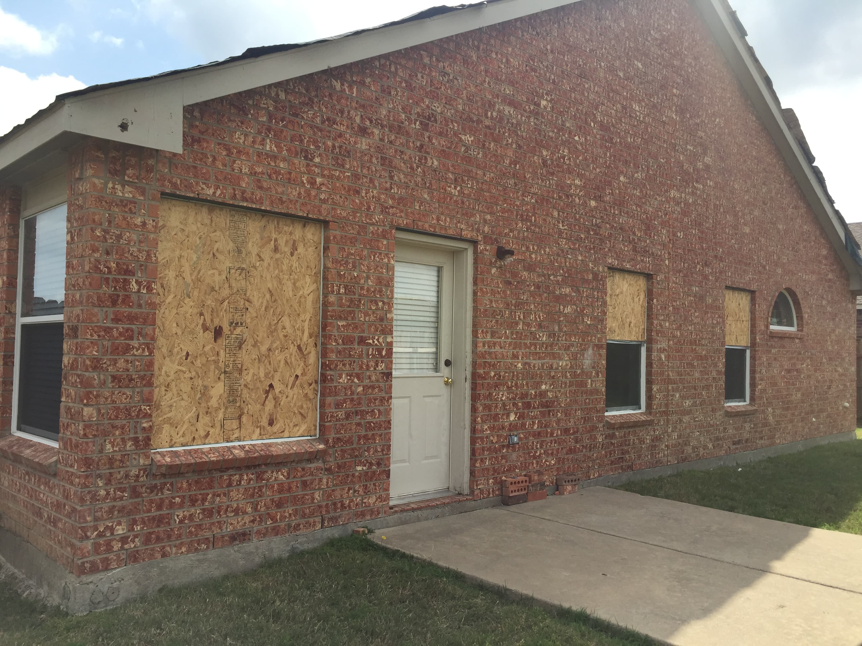 Close-up of professional window replacement in progress on the exterior of a suburban house.