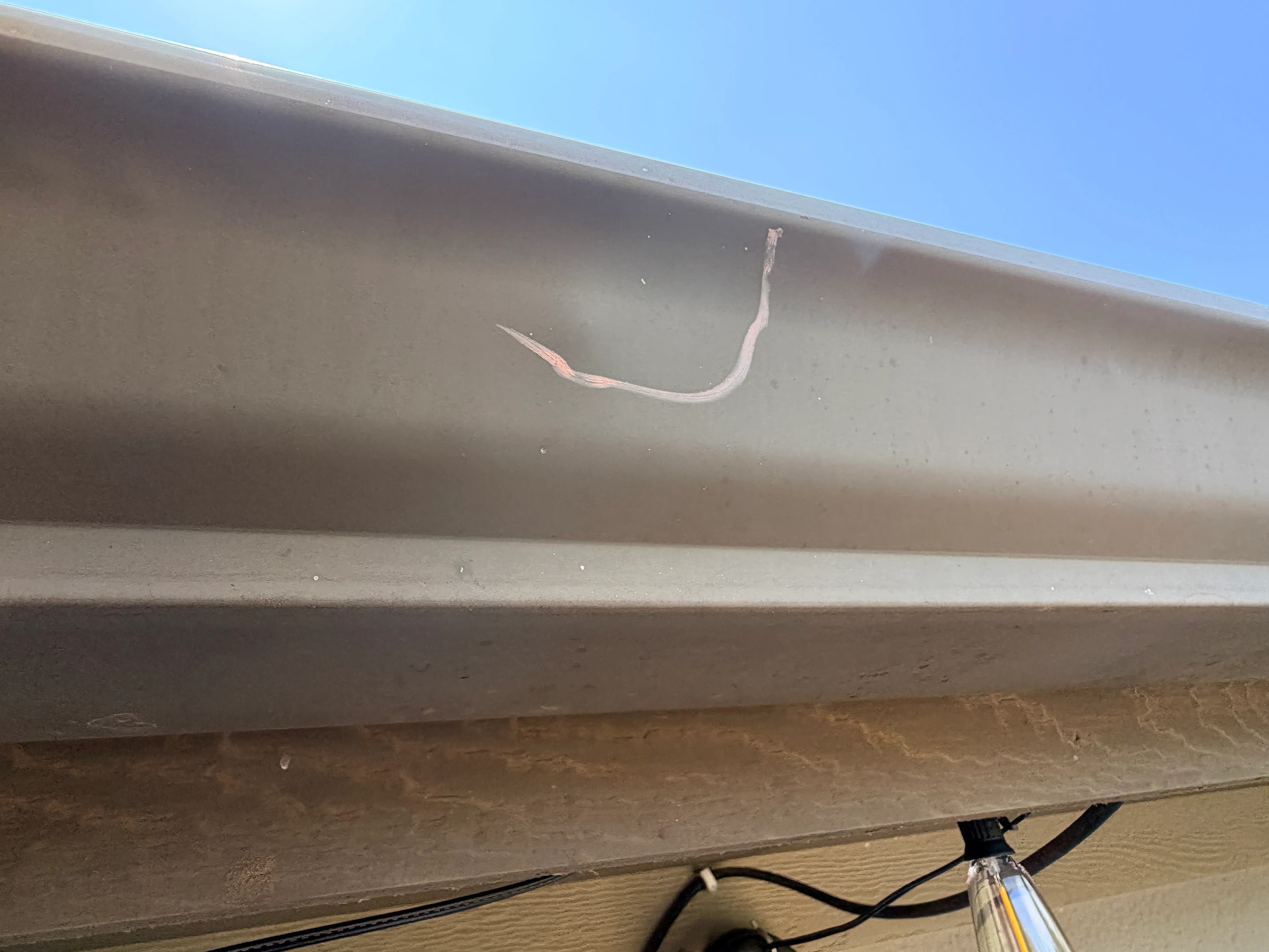 hail damage found and marked on the metal gutter - OKC
